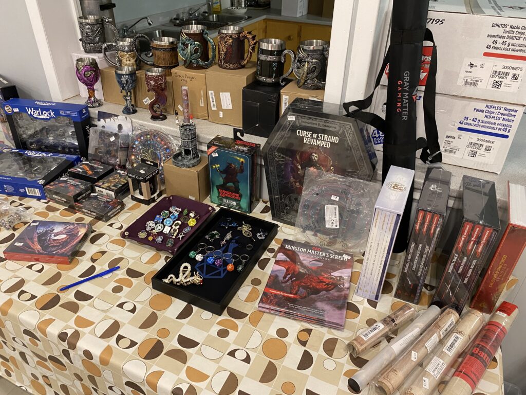 Photo of the DFT Popup store from a 2024, with mugs, books, keychains, and more