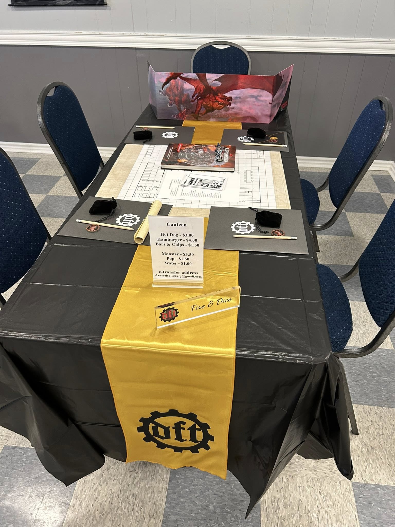 Table Layout from DFT 3 - shows folders at each person's place, a DM screen, and a yellow DFT banner